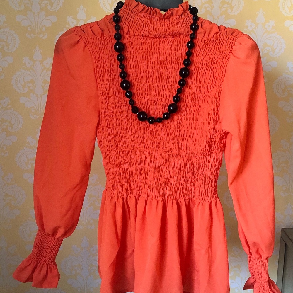 Like new, never worn orange ruffled blouse